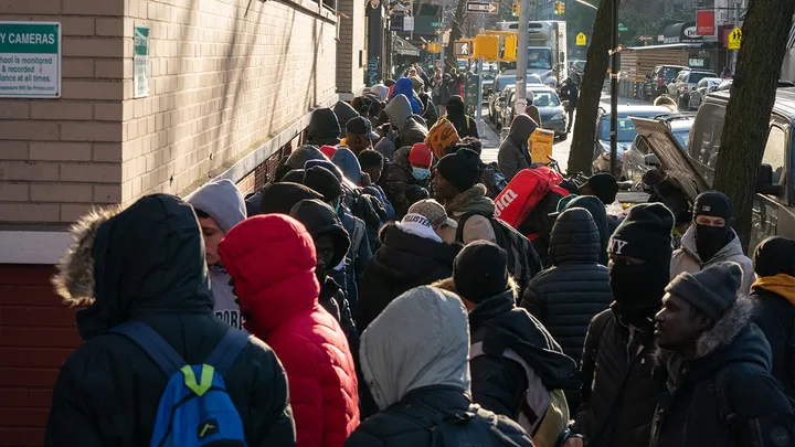 Migrants line up outside a migrant re-ticketing center at St. Brigid School on E. 7th St. Friday, Jan. 5, 2024, in Manhattan, New York City. (Barry Williams/New York Daily News/Tribune News Service via Getty Images)