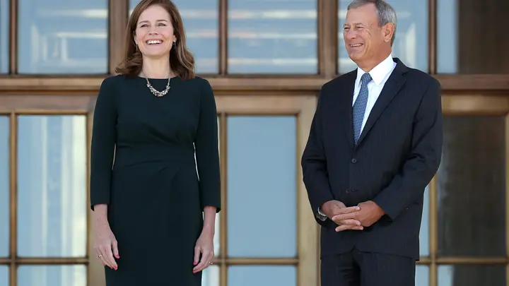 Supreme Court Justice Amy Coney Barrett and Chief Justice John Roberts pause for photographs at the top of the steps of the west side of the Supreme Court following her investiture ceremony on October 1, 2021, in Washington, DC. (Chip Somodevilla/Getty Images)