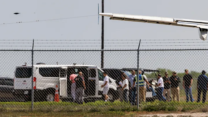 Shackled migrants board a transport van after getting off a plane at the Valley International Airport, Sunday, Aug. 31, 2025, in Harlingen, Texas. (Michael Gonzalez/AP Photo)