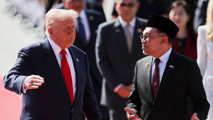 U.S. President Donald Trump talks with Malaysia Prime Minister Anwar Ibrahim as he arrives at Kuala Lumpur International Airport. (AP)