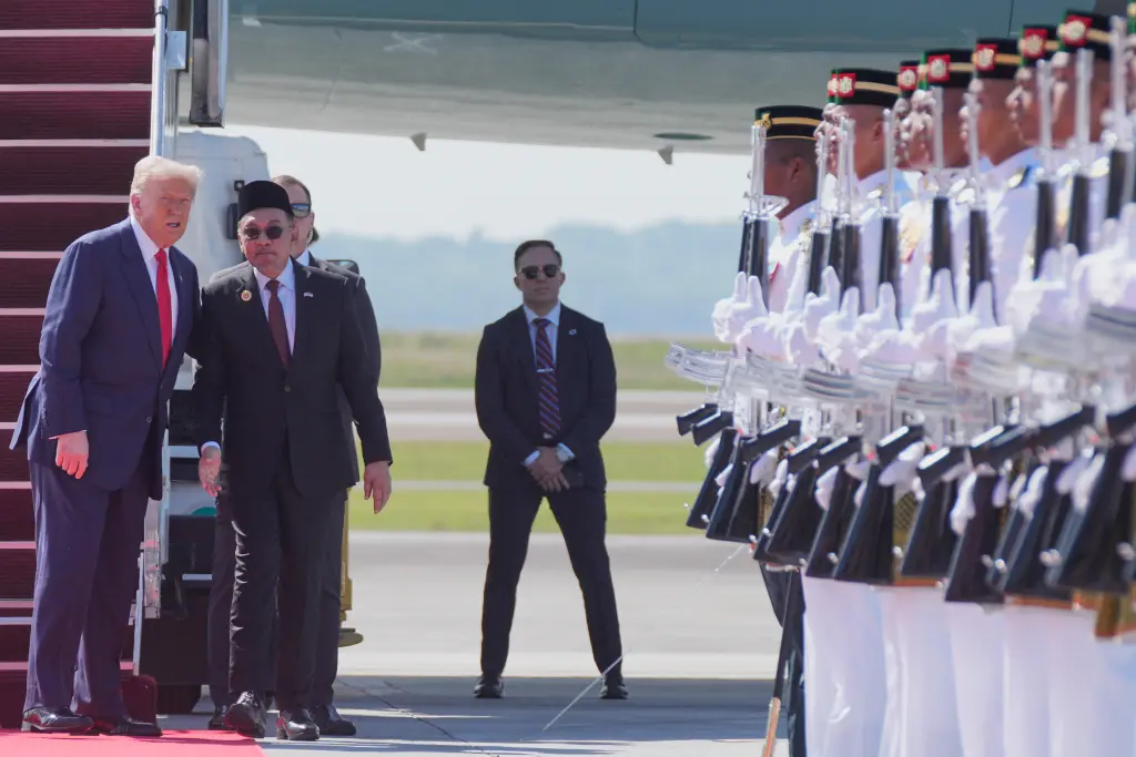 The president was greeted by local armed forces as he arrived in Kuala Lampur. AP
