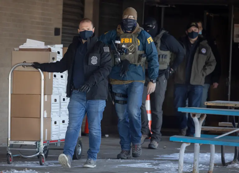FBI agents during a raid of the Twin Cities nonprofit Feeding Our Future, which took part in the largest welfare fraud scheme in US history. Star Tribune via Getty Images