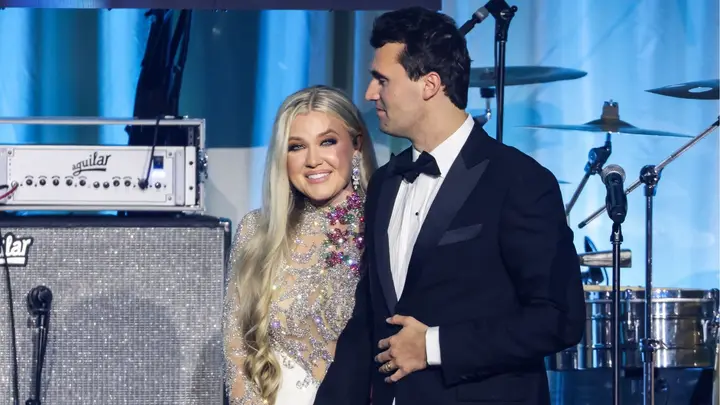 Conservative activist Charlie Kirk is pictured with his wife Erika Kirk on stage at an event earlier this year in Phoenix. Erika Kirk has since stepped into the spotlight following his death. (Samuel Corum/Getty Images)