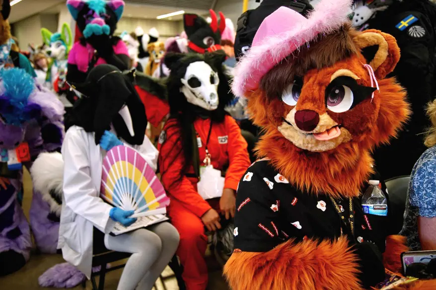 Attendees in various animal costumes at Anthrocon 2023. AFP via Getty Images