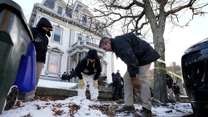 Members of the FBI Evidence Response Team search for evidence near the campus of Brown University, Monday, Dec. 15, 2025, in Providence, R.I. (Robert F. Bukaty/AP Photo)