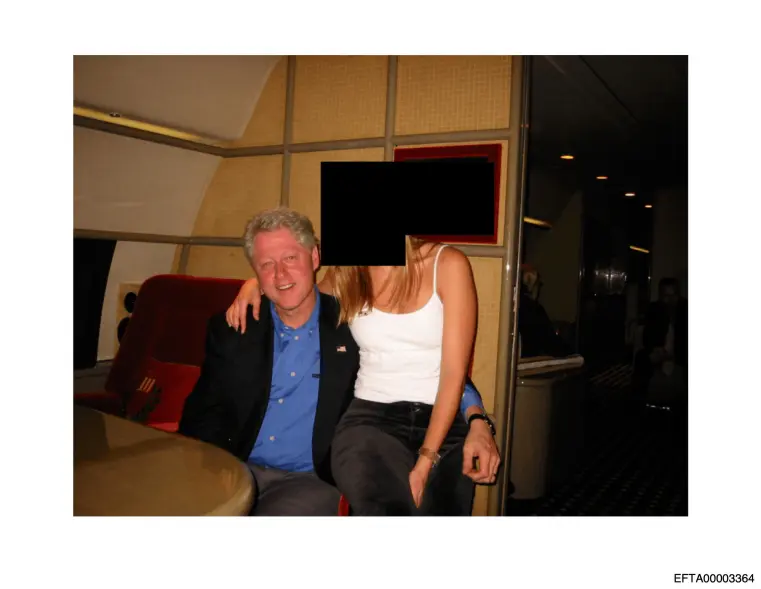 This undated, redacted photo from the DOJ shows Clinton with an unknown person on a private jet. AP