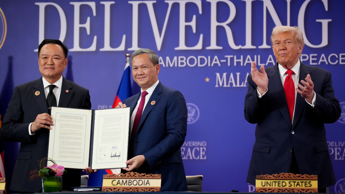 Thai Prime Minister Anutin Charnvirakul and Cambodian Prime Minister Hun Manet shake hands following the signing of a Cambodia-Thailand peace deal as U.S. President Donald Trump reacts at Kuala Lumpur Convention Centre on October 26, 2025, in Kuala Lumpur, Malaysia. (Andrew Harnik/Getty Images)