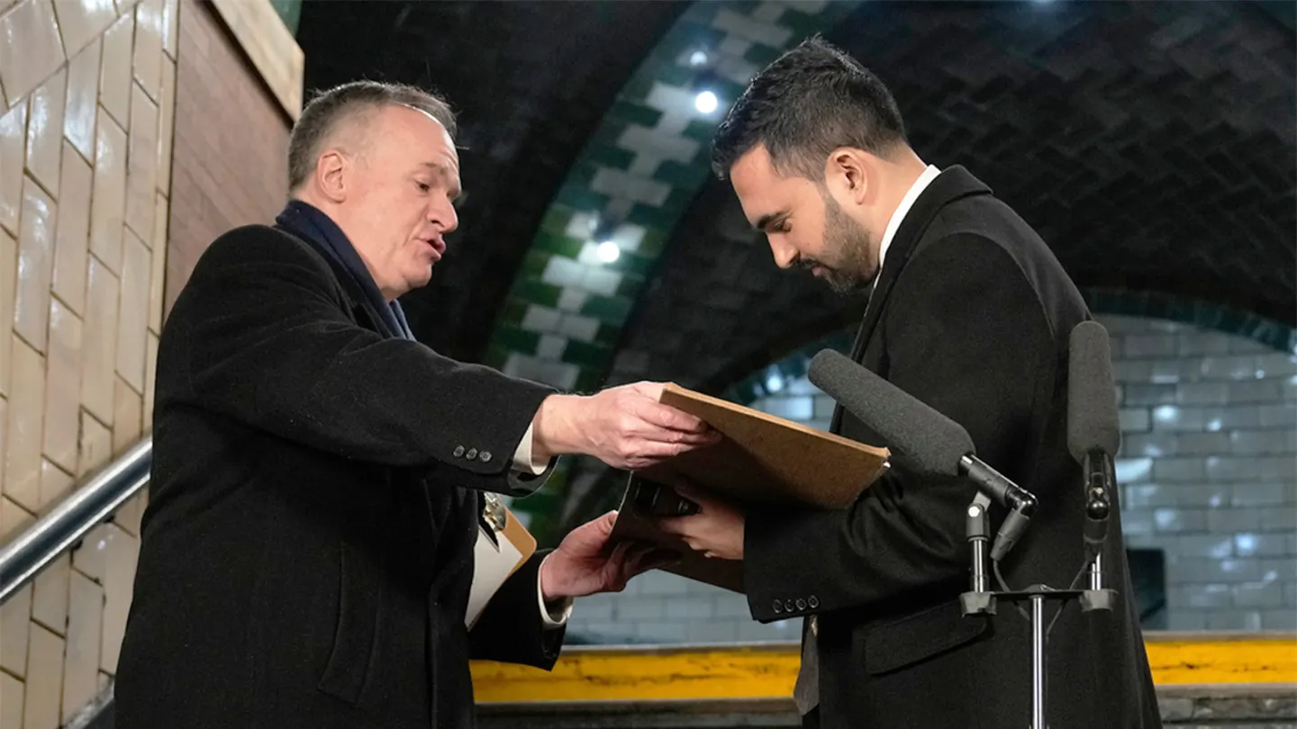 New York Mayor Zohran Mamdani signs a registry as City Clerk Michael McSweeney holds the book after Mamdani was sworn in as mayor, Thursday, Jan. 1, 2026, in New York. (AP Photo/Yuki Iwamura)