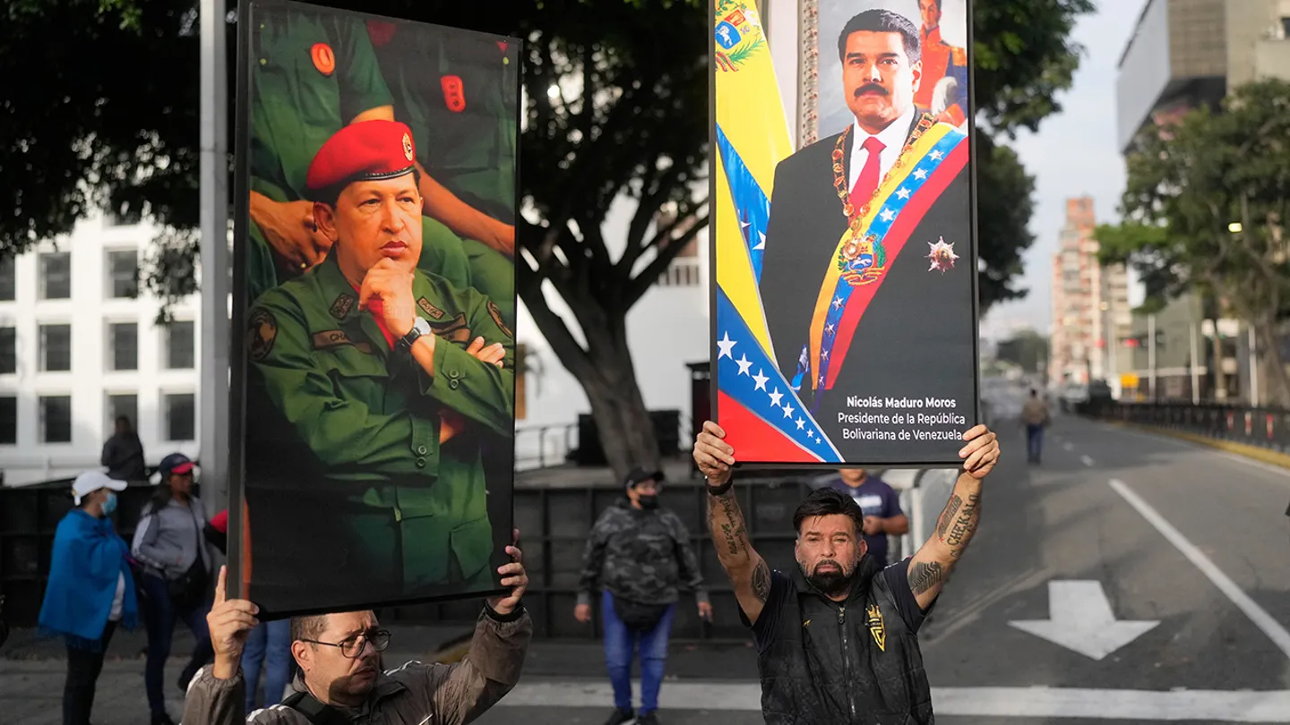 Government supporters display posters of Venezuelan President Nicol&aacute;s Maduro, right, and former President Hugo Ch&aacute;vez in downtown Caracas, Venezuela, on Saturday, Jan. 3, 2026, after U.S. President Donald Trump announced that Maduro had been captured and flown out of the country. (Matias Delacroix/AP)