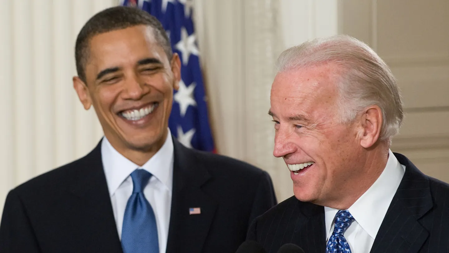 President Barack Obama smiles alongside Vice President Joe Biden before signing healthcare insurance reform legislation at the White House on March 23, 2010. (Saul Loeb/AFP via Getty Images)