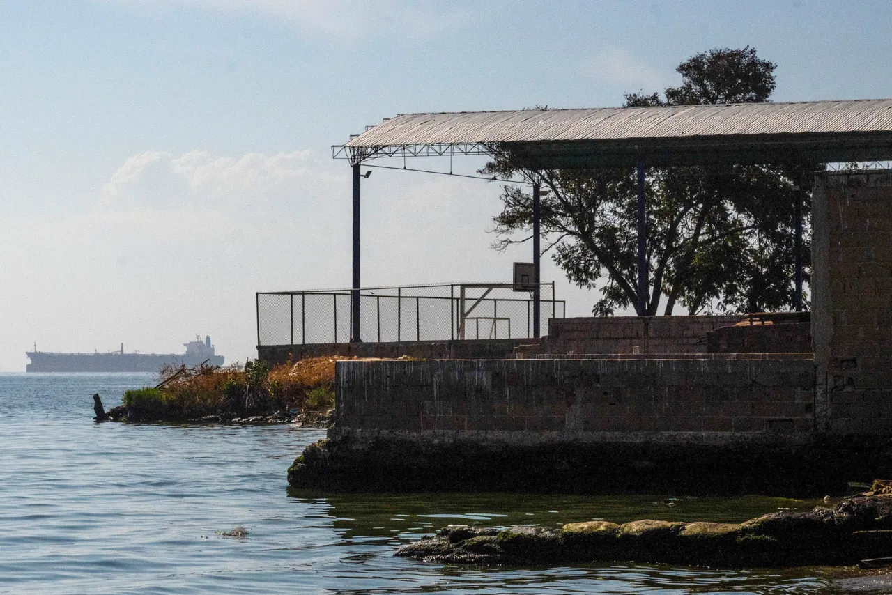 A crude oil tanker sails on the shore of Lake Maracaibo, Zulia state, Venezuela, on December 31, 2025. On December 30, 2025, Colombian President Gustavo Petro said the United States bombed a suspected cocaine factory in the port city of Maracaibo, Venezuela. (Photo by Maryorin Mendez / AFP via Getty Images)