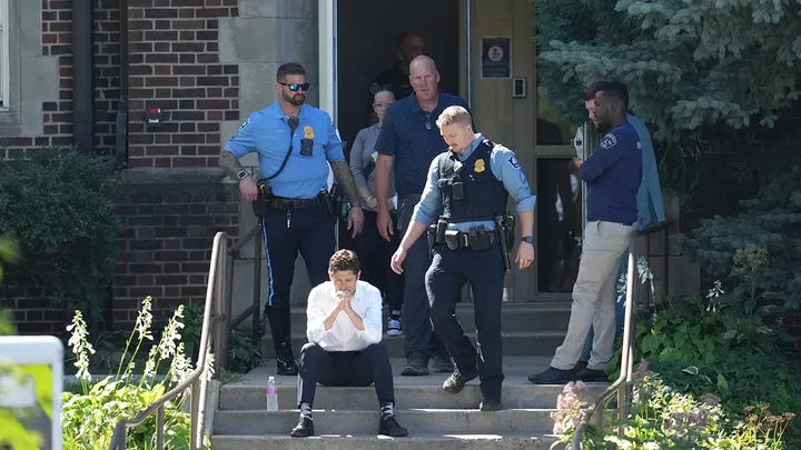 Mayor Jacob Frey sits on steps of the Annunciation Church's school as police respond to a mass shooting on Aug. 27, 2025, in Minneapolis. (Abbie Parr/AP Photo)