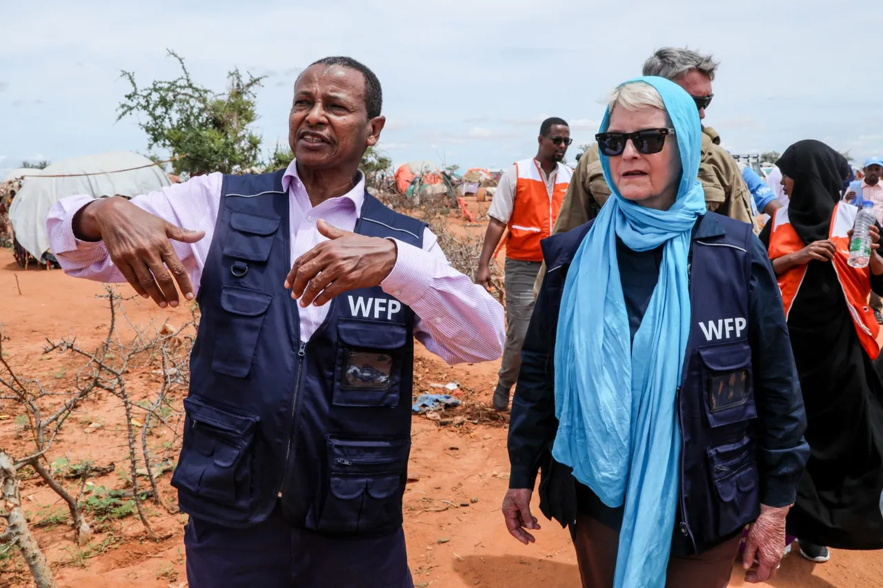 Cindy McCain (R), World Food Programme (WFP) Executive Director, listens to El-Khidir Daloum, WFP Somalia Representative and Country Director, during her visit to assess drought conditions at the Ladan internally displaced people (IDP) camp in Dolow on May 1, 2023. (Photo by HASSAN ALI ELMI/AFP via Getty Images)