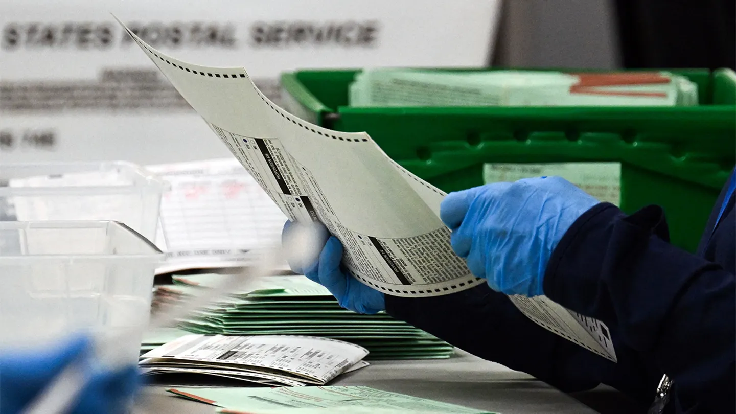 An election worker tabulating a ballot. (Patrick T. Fallon/AFP via Getty Images)