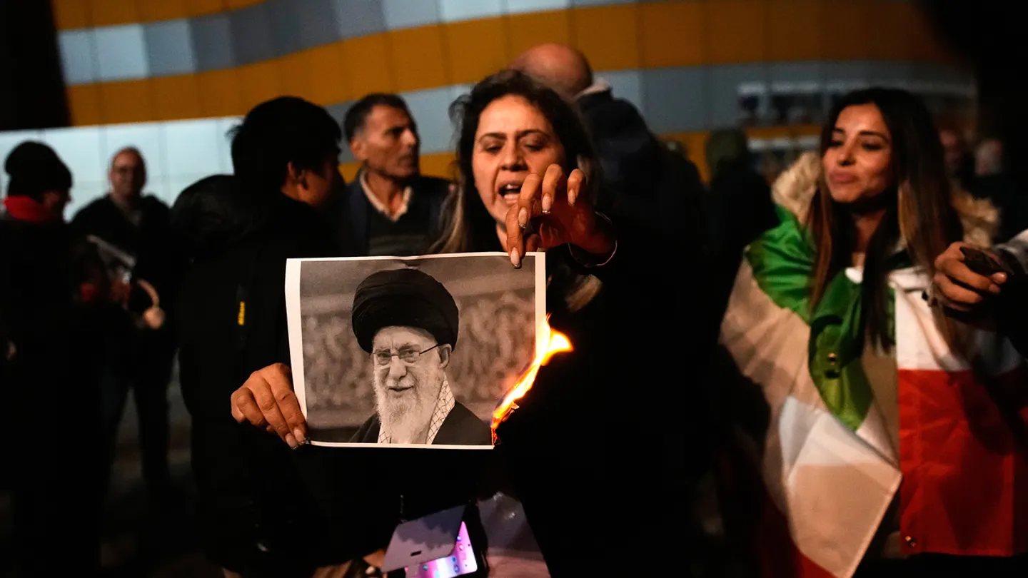 Demonstrators burn a poster depicting Ayatollah Ali Khamenei during a rally in support of anti-government protests in Iran, in Holon, Israel, Jan. 14, 2026. (AP Photo/Ohad Zwigenberg)