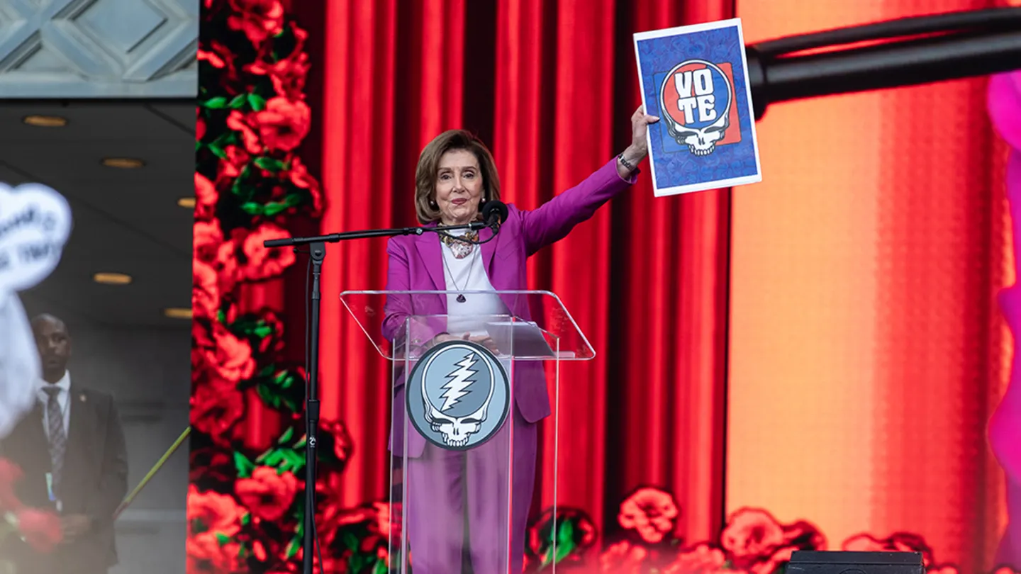 Others criticized Pelosi's bright magenta suit, a stark contrast from the black clothing worn by most others on stage at the event. (Miikka Skaffari/Getty Images)
