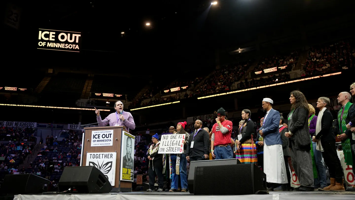People listen to speeches during an anti-ICE rally at the Target Center Friday in Minneapolis. (AP Photo/Angelina Katsanis)