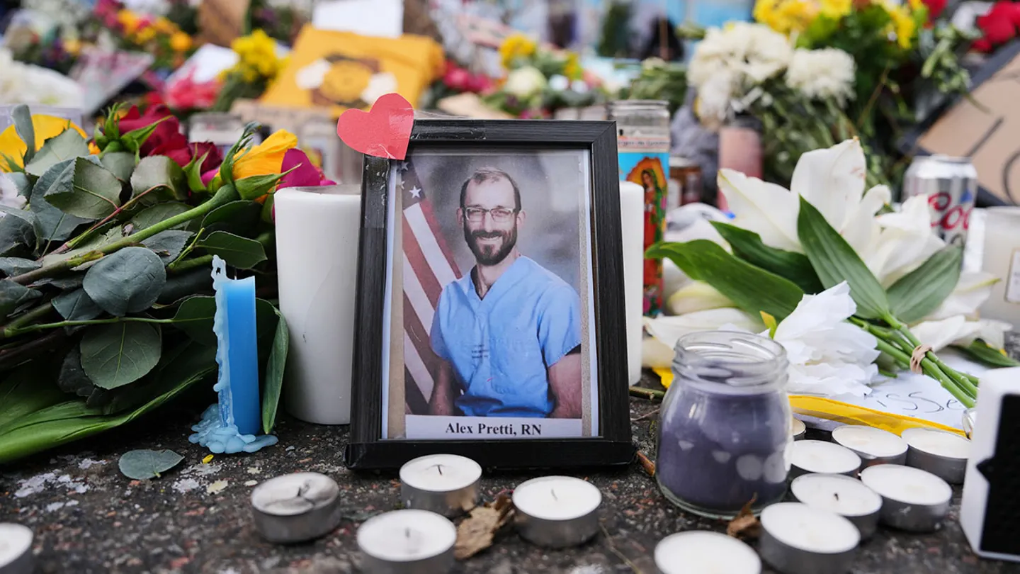 A photo of 37-year-old Alex Pretti, who was fatally shot by a U.S. Border Patrol officer over the weekend, is displayed at the shooting scene Monday in Minneapolis. The Department of Homeland Security is investigating whether U.S. Border Patrol agents thought they were being fired upon when one fatally shot Pretti. (AP Photo/Adam Gray)