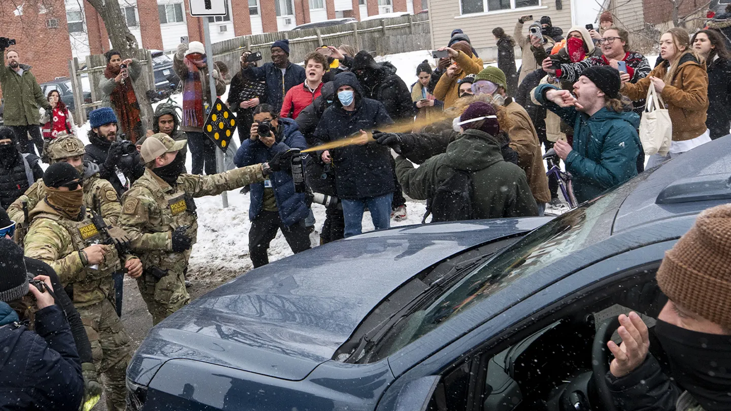 A Border Patrol member pepper sprays observers after getting into a car accident on Jan. 21, 2026, in Minneapolis. (Stephen Maturen/Getty Images)