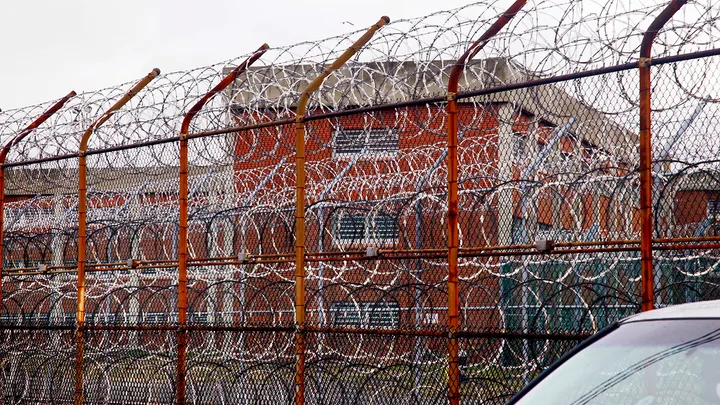 A security fence surrounds the inmate housing on New York's Rikers Island correctional facility in New York.  (AP/Bebeto Matthews)