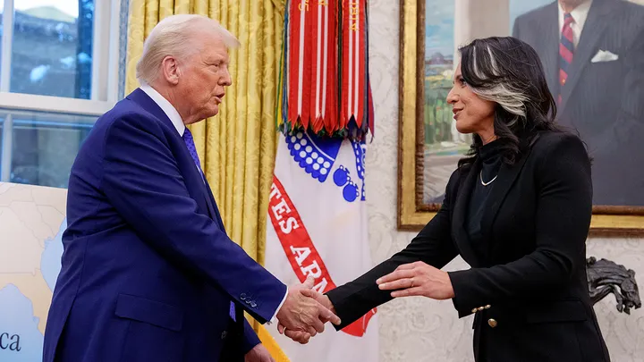 Director of National Intelligence Tulsi Gabbard shakes hands with President Donald Trump in the Oval Office at the White House.  (Andrew Harnik/Getty Images)