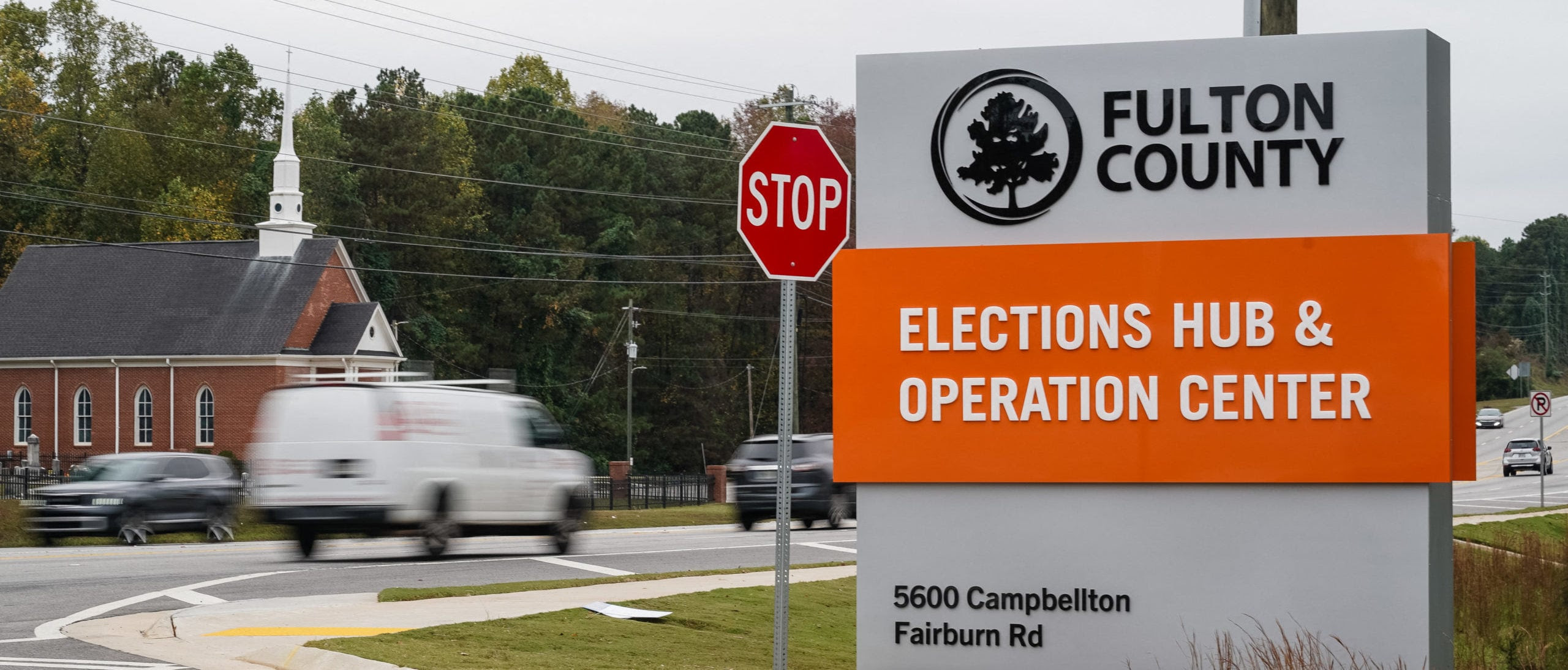  Vehicles pass by the sign for the Fulton County Elections Hub and Operations Center on November 4, 2024, in Union City, Georgia. (Photo by Elijah Nouvelage / AFP) (Photo by ELIJAH NOUVELAGE/AFP via Getty Images)