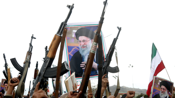 On March 1, 2026, in Sana'a, Yemen, pro-Iran protesters brandish billboards depicting the Iranian Supreme Leader Ali Hosseini Khamenei, flags of Yemen and Iran, weapons, and chant slogans at a rally held to condemn the U.S.-Israel aerial attacks on Iran and the killing of Khamenei and several military officials. (Mohammed Hamoud/Getty Images)