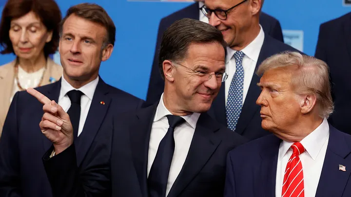 President Donald Trump, right, speaks with NATO Secretary General Mark Rutte during a group photo of NATO heads of state and government at the NATO summit in The Hague, Netherlands, Wednesday, June 25, 2025.  (AP Photo/Geert Vanden Wijngaert)