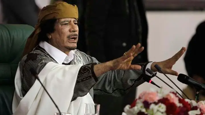 Libyan Leader Moammar Gadhafi gestures to supporters as he speaks in Tripoli, Libya. As rebels swarmed into Tripoli late Sunday, Aug. 21, 2011. (Associated Press)