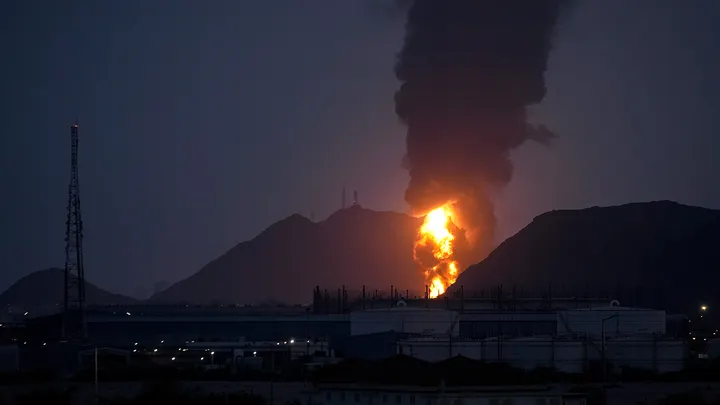 A large fire and plume of smoke is visible after, according to the authorities, debris of an Iranian intercepted drone hit the Fujairah oil facility, in Fujairah, United Arab Emirates, Tuesday. (Altaf Qadri/AP Photo)