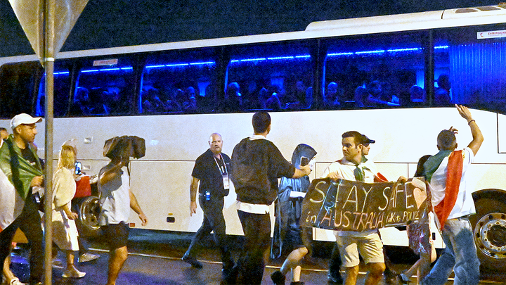 Supporters react towards a bus transporting Iranian woman players following their Women's Asian Cup soccer match against the Philippines on the Gold Coast, Australia, Sunday, March 8, 2026. (Dave Hunt/AAP Image via AP)