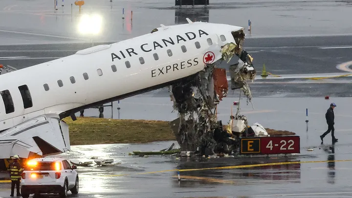 An Air Canada Express CRJ-900 sits on the runway after colliding with a Port Authority fire truck at LaGuardia Airport in New York on March 23, 2026. (Timothy A. Clary/ AFP via Getty Images)
