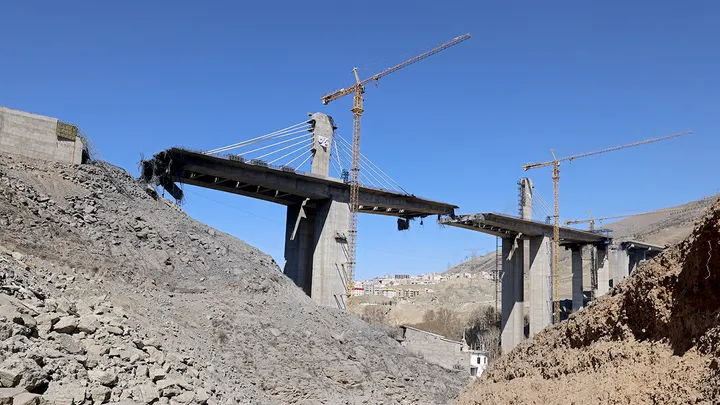 A man takes pictures with his mobile phone of the B1 bridge, a day after it was destroyed by a strike in Karaj, around 20 miles (35kms) southwest of Tehran, Iran, April 3, 2026. (ATTA KENARE / AFP via Getty Images)