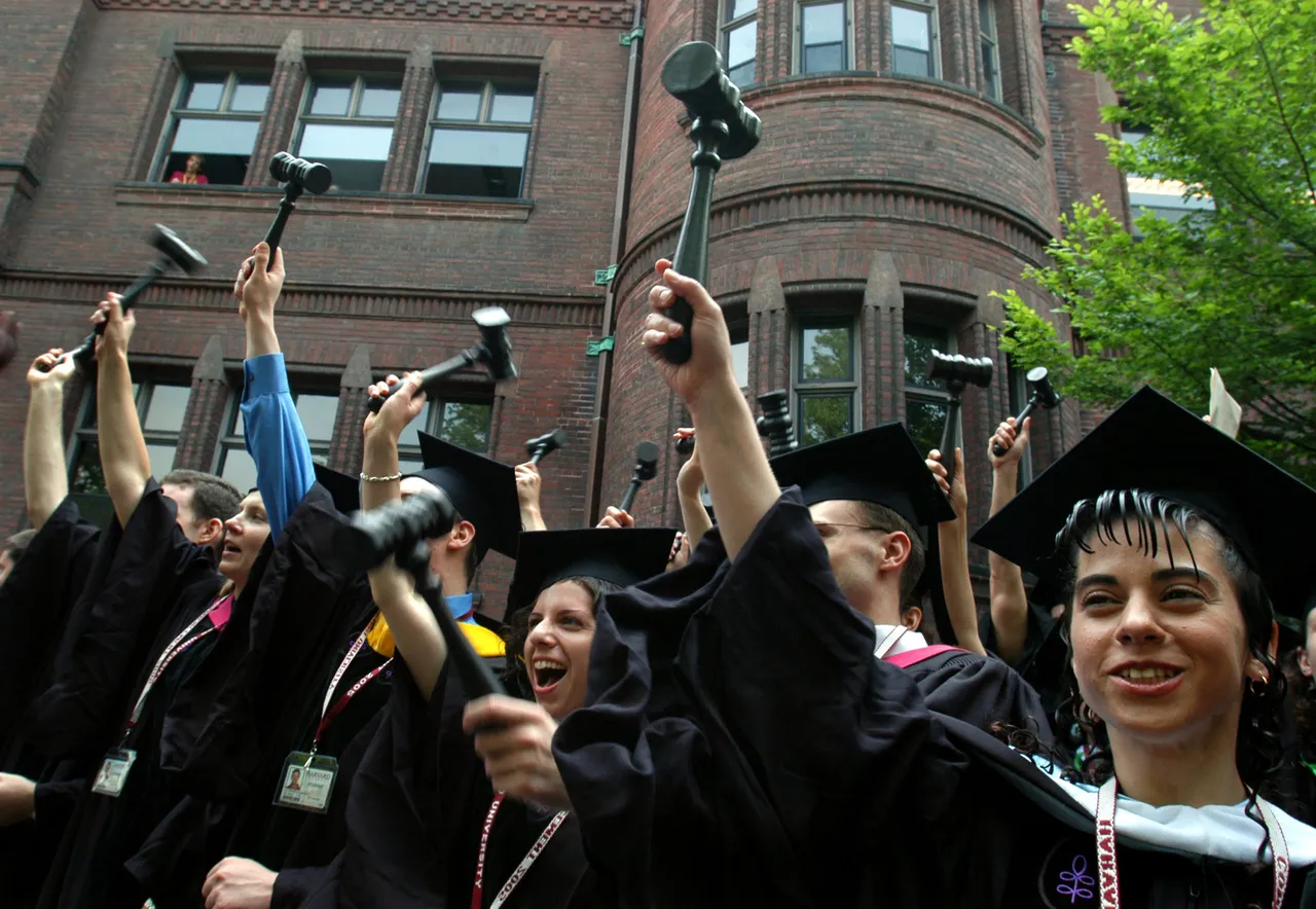Harvard Law School graduates celebrate by waving gavels during Harvard University Commencement exercises in June 9, 2005 in Cambridge, Massachusetts. (Photo by William B. Plowman/Getty Images)