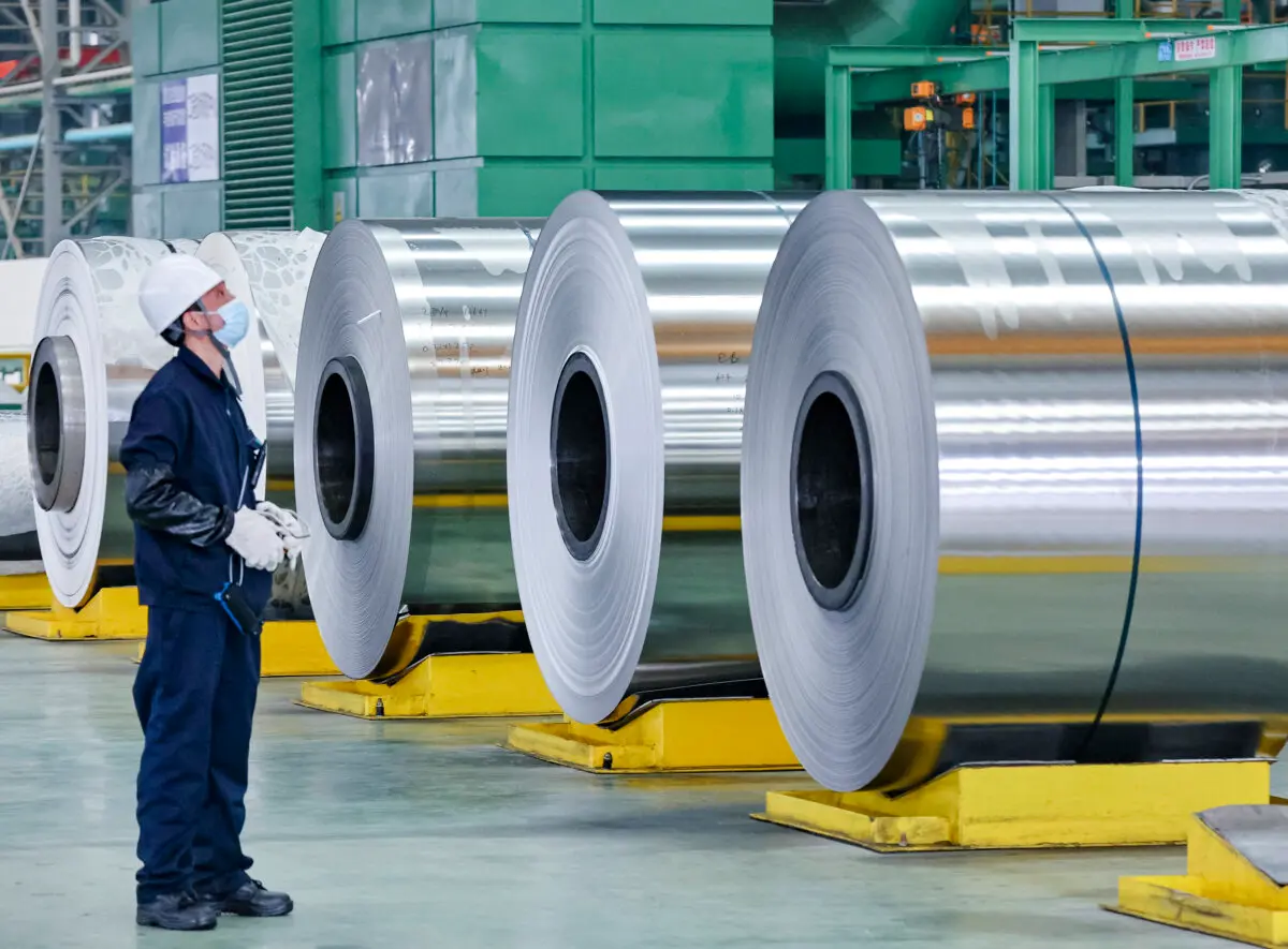 An employee looks on at steel rolls at a factory in Nantong, Jiangsu Province, China, on March 1, 2022. (STR/AFP via Getty Images)