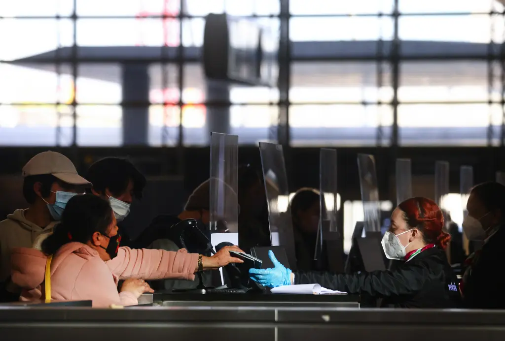 A traveler hands her passport to an airline agent at Los Angeles International Airport. Getty Images