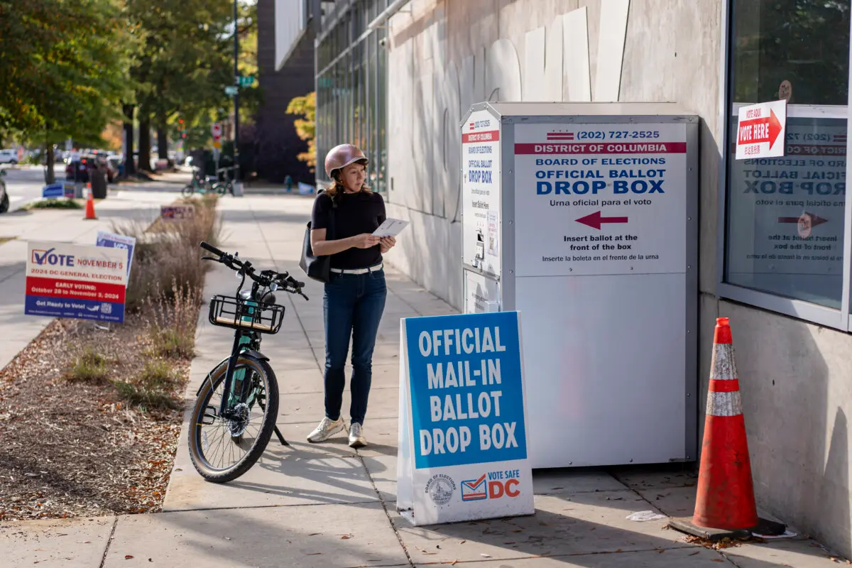 A woman casts her mail-in vote at an official ballot drop box in Washington on Nov. 5, 2024. Madalina Vasiliu/The Epoch Times