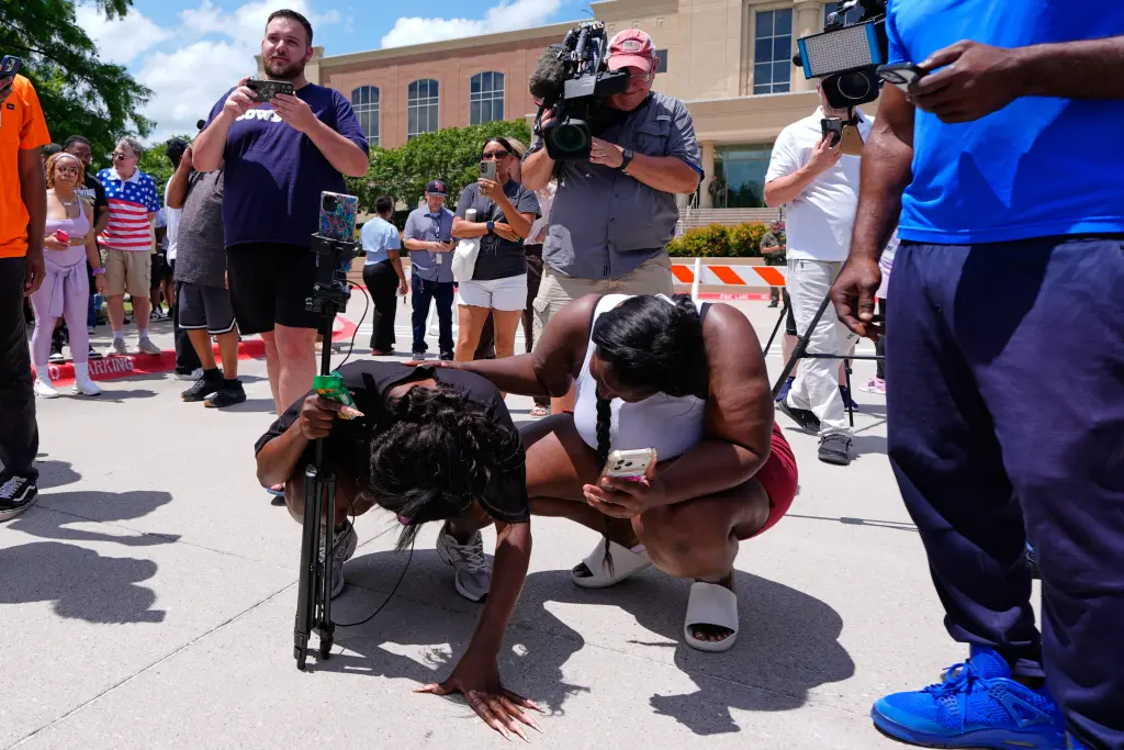 People reacting to Anthony’s guilty verdict. AP Photo/Tony Gutierrez