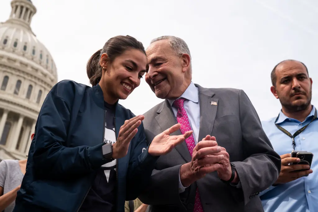 Rep Alexandria Ocasio-Cortez (left) with Senate Minority Leader Chuck Schumer (center). Los Angeles Times via Getty Images
